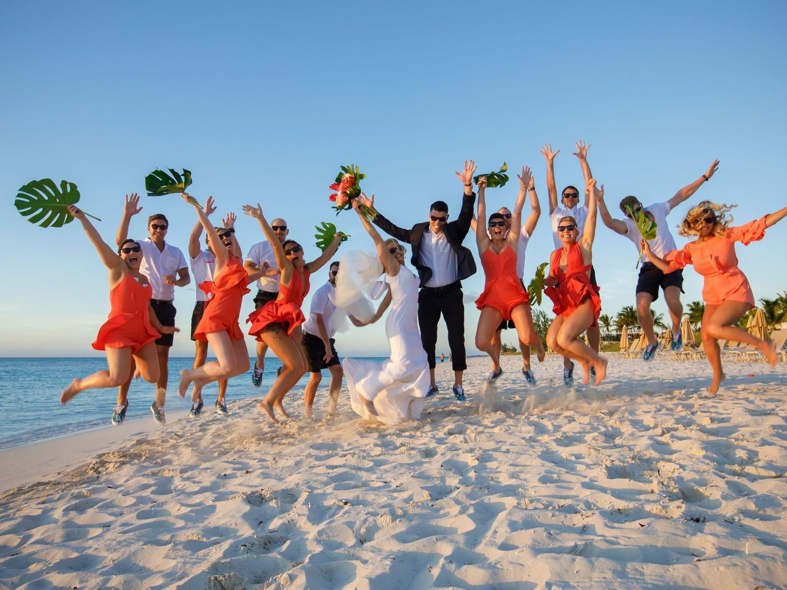 Wedding crew posing at the beach near The Somerset on Grace Bay