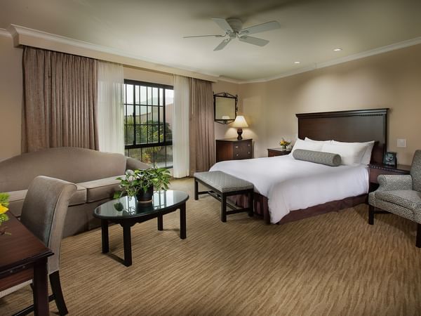 King bed in hotel suite with living area