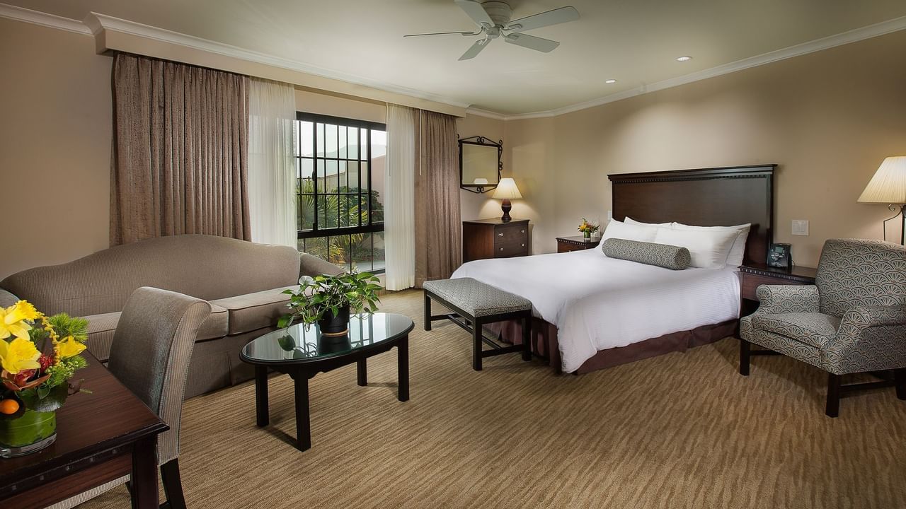 King bed in hotel suite with living area