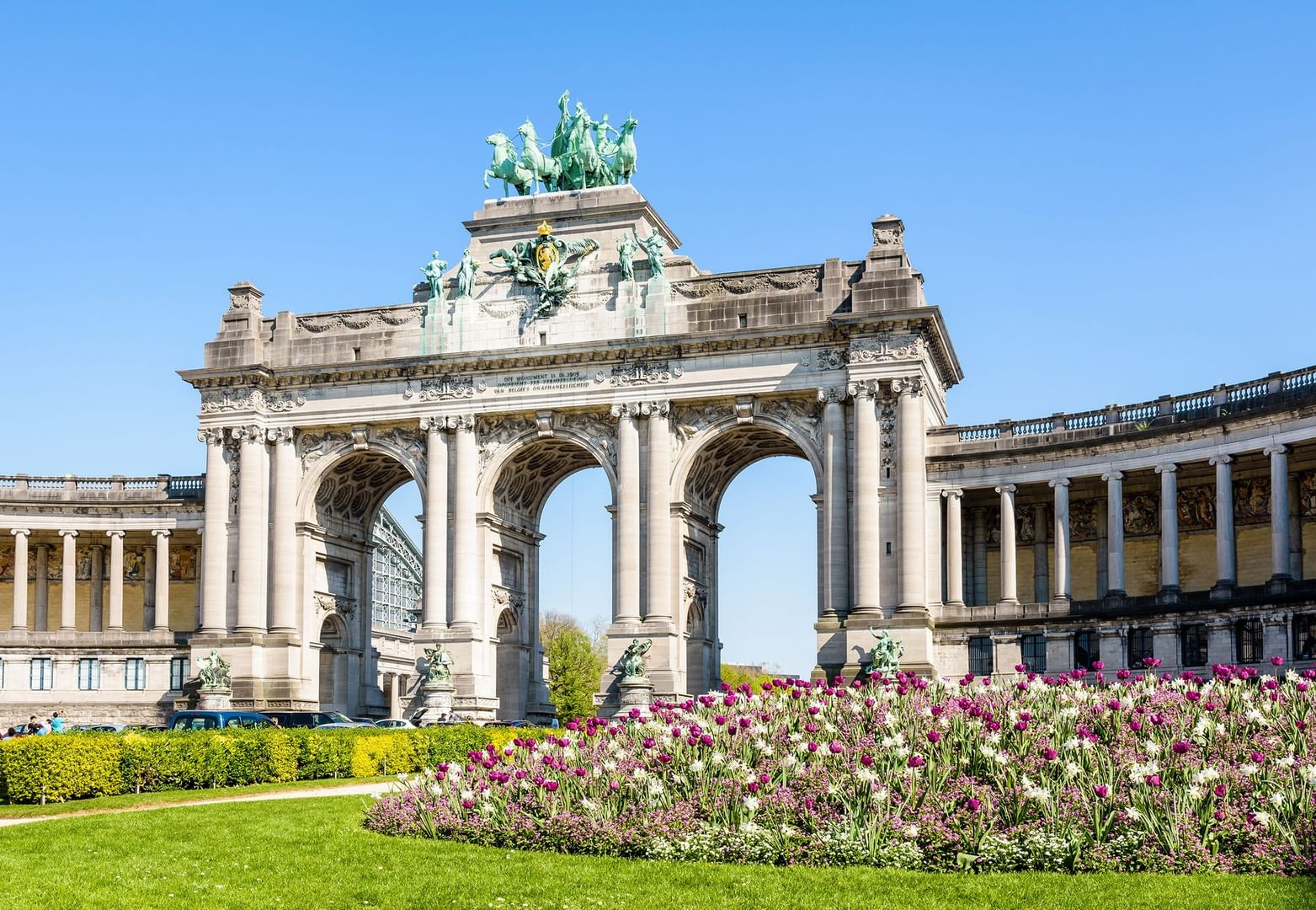 A grand building with statues and an archway set in a park with flowers at Barsey by Warwick 