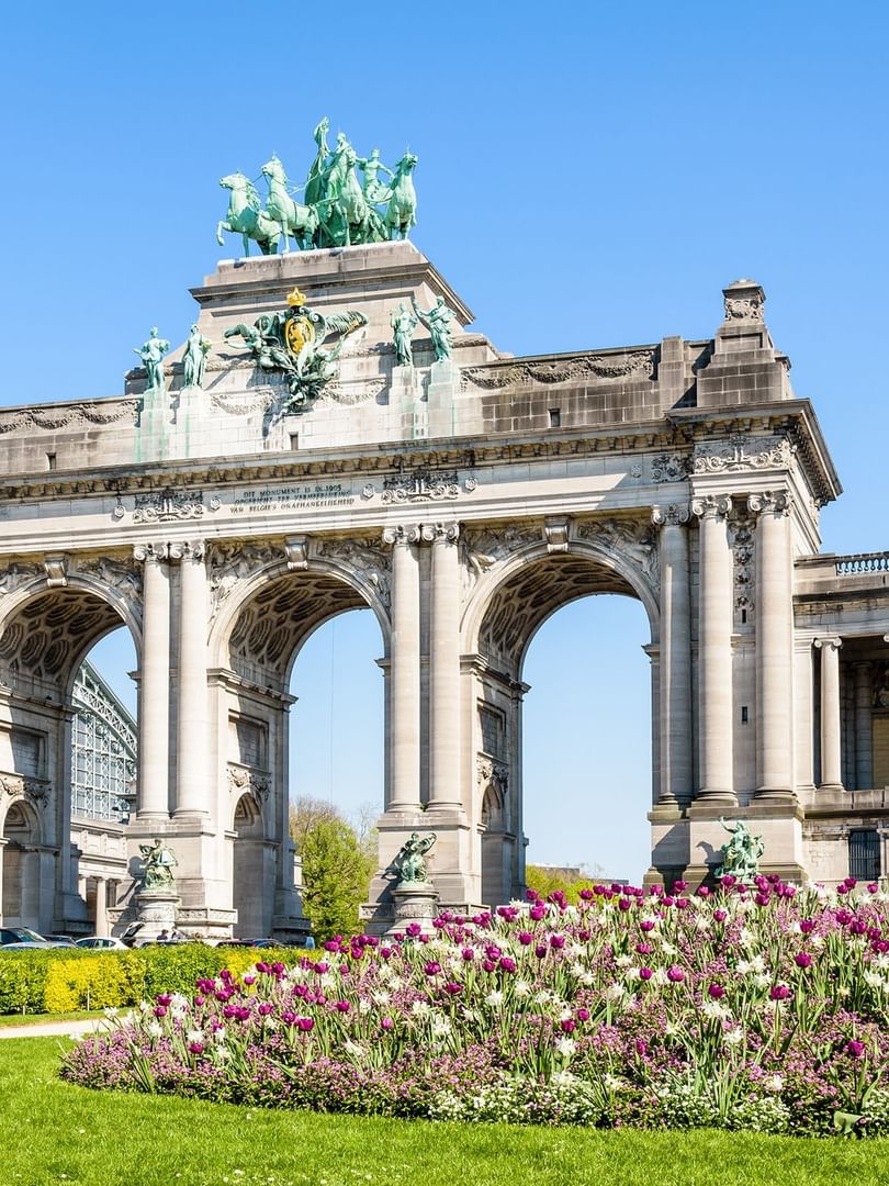 Arcade du Cinquantenaire with flowers set against lush green lawn at Hotel Barsey by Warwick
