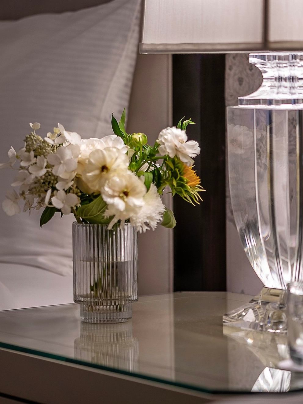 Table with flowers and a lamp in the Junior Suite at Warwick New York