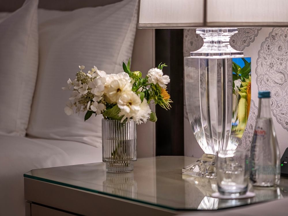 Table with flowers and a lamp in the Junior Suite at Warwick New York