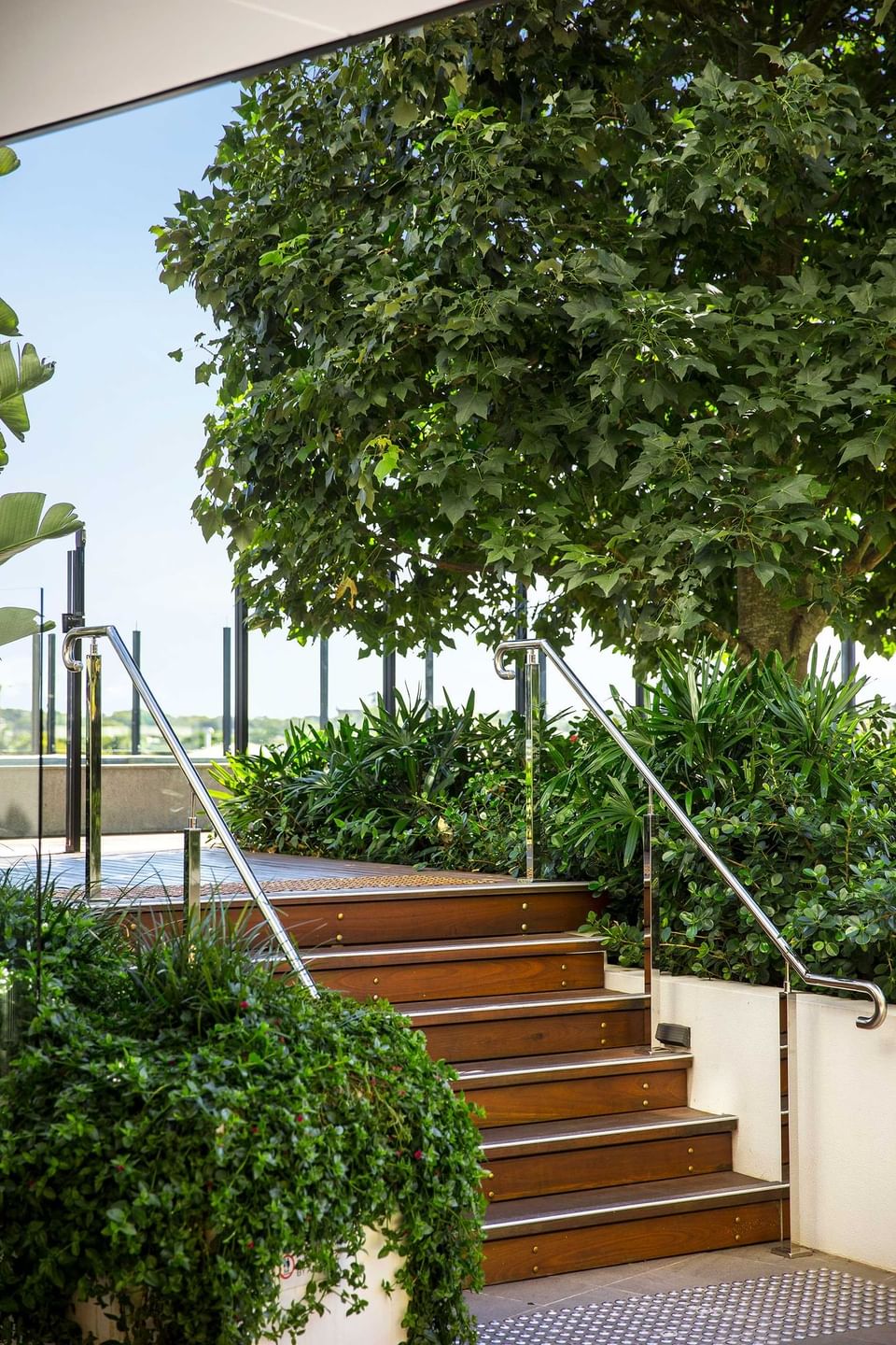 Stairs through greenery plants at Alcyone Hotel Residences