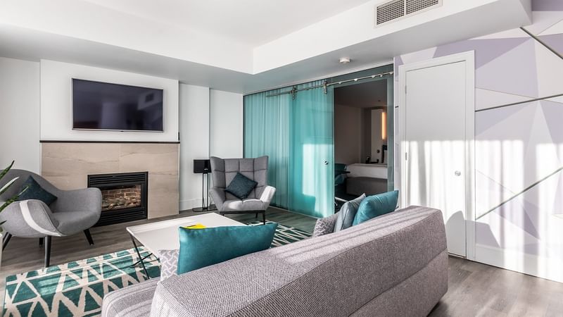 Living area with TV & sofa chairs in Penthouse Suite Crescent at Warwick Le Crystal