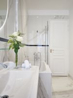 Deluxe Suite Belle Époque bathroom featuring a marble vanity with bathtub at Hotel Westminster Paris