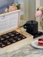 Box of Dammann teas, a macaron, and a tea set on a marble table at Hôtel Westminster Paris.