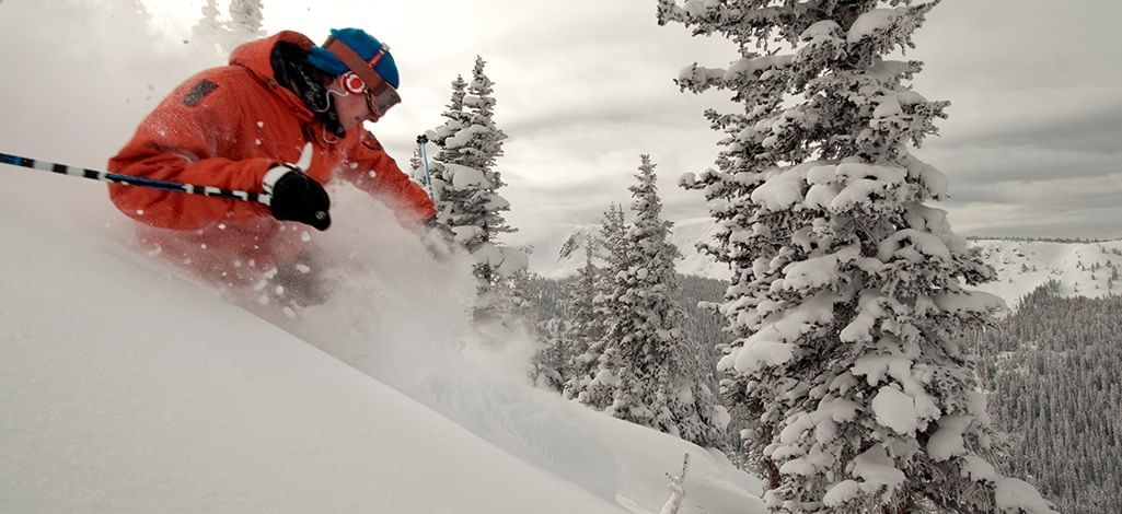 steep in-bounds skier in lots of powder snow