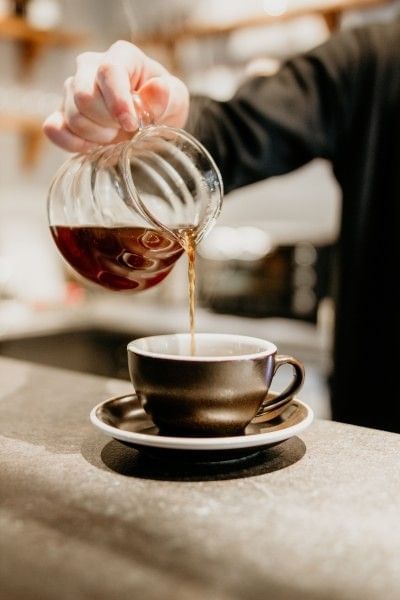 A person pouring coffee at one of the best coffee shops in Orlando near Rosen Inn International.