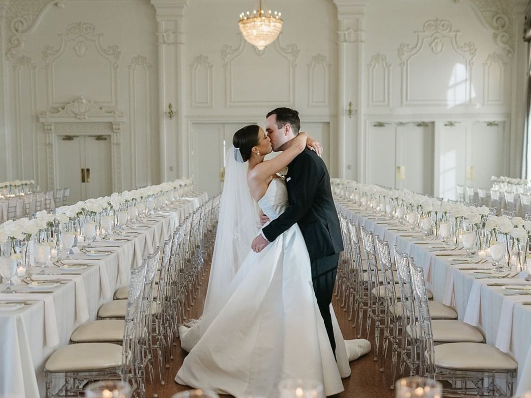 Wedded couple kissing in Crystal Ballroom at The Mayo Hotel