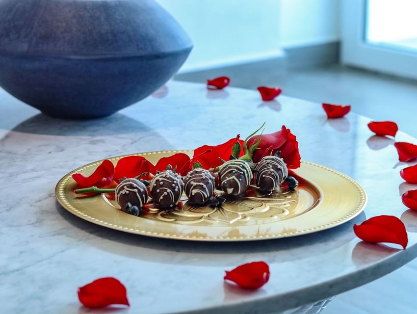 Chocolate truffles and a red rose on a gold plate, a romantic amenity at Almar Resort, a welcoming Gay hotel Puerto Vallarta