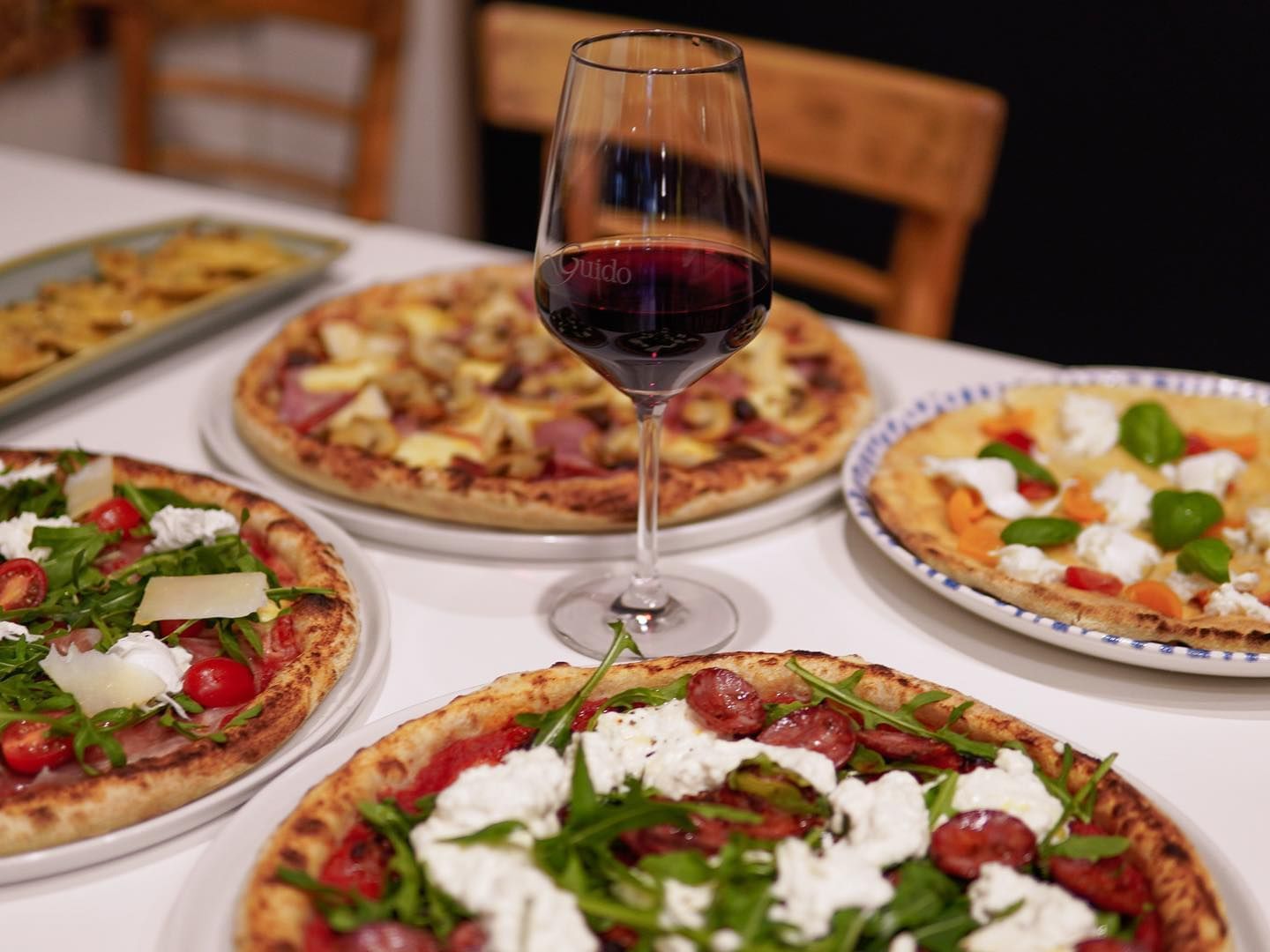 Pizza and glass of red wine served at Brady Hardware Lane