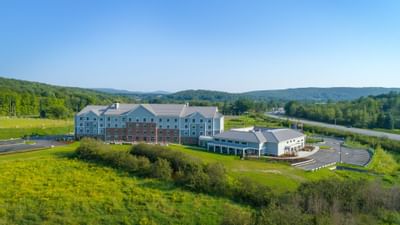 aerial shot of hotel surrounded by green land
