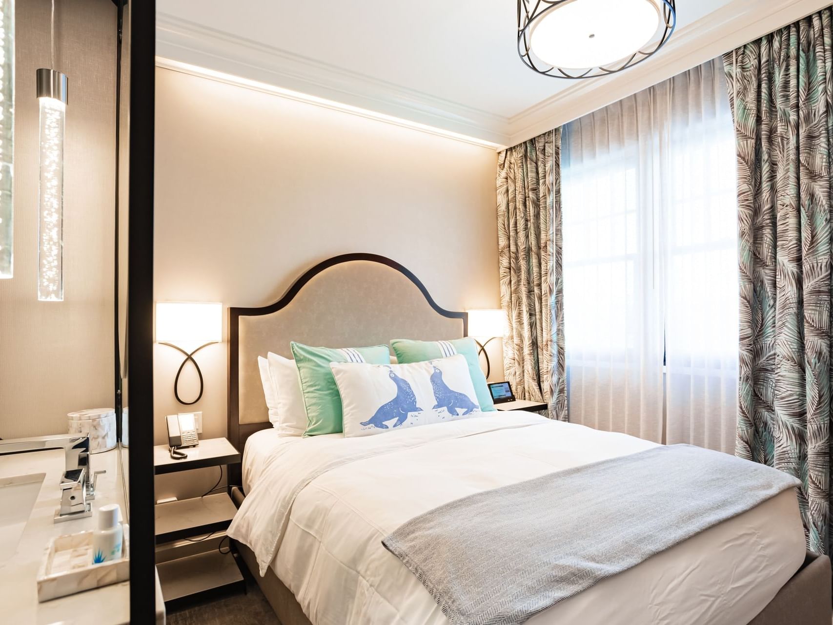 Bathtub and nightstand by the king bed in Classic King at Hotel Atwater