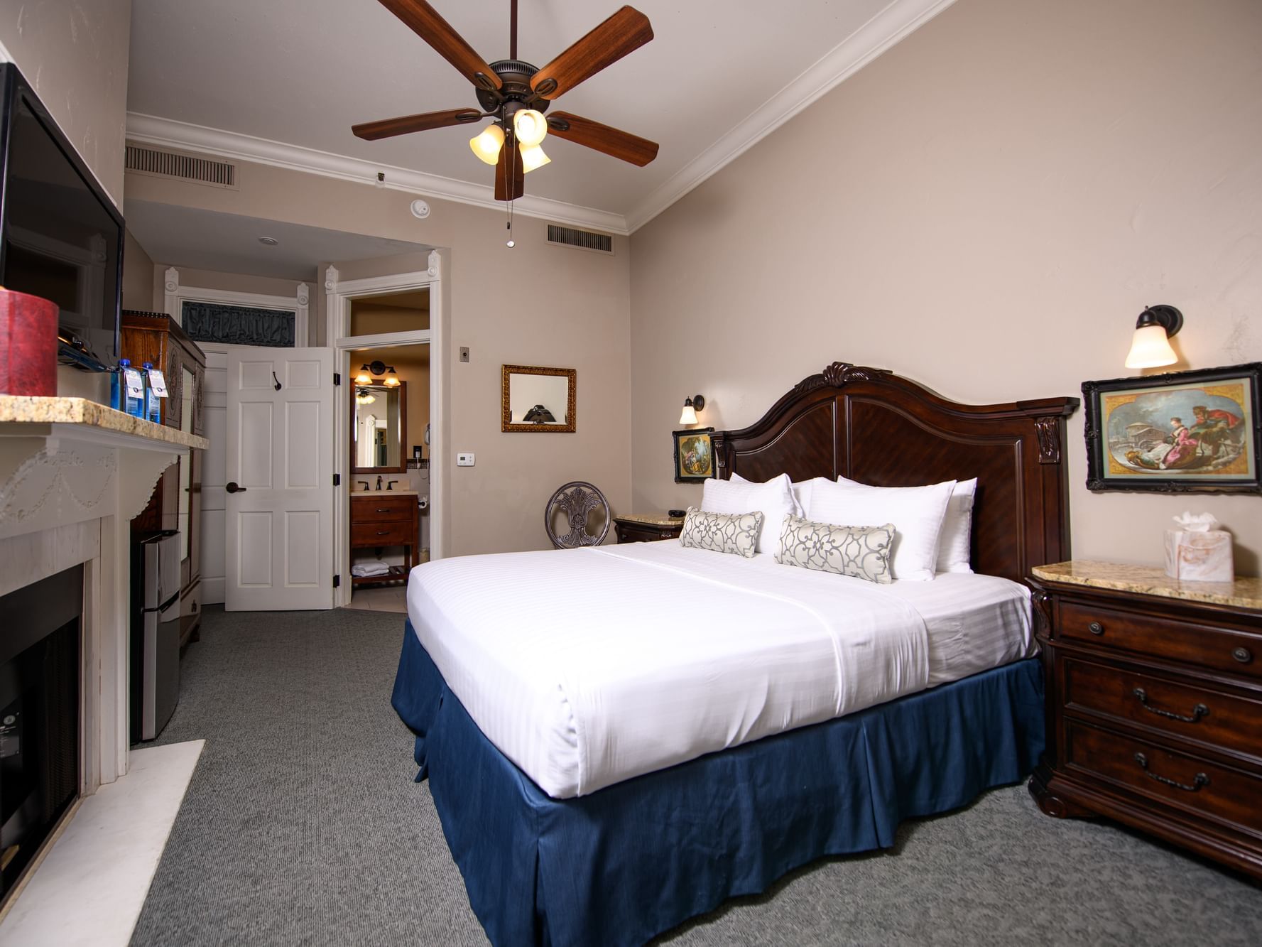 TV, fireplace and cupboard by the bed in 1 King Bed Room with Balcony at Horton Grand Hotel