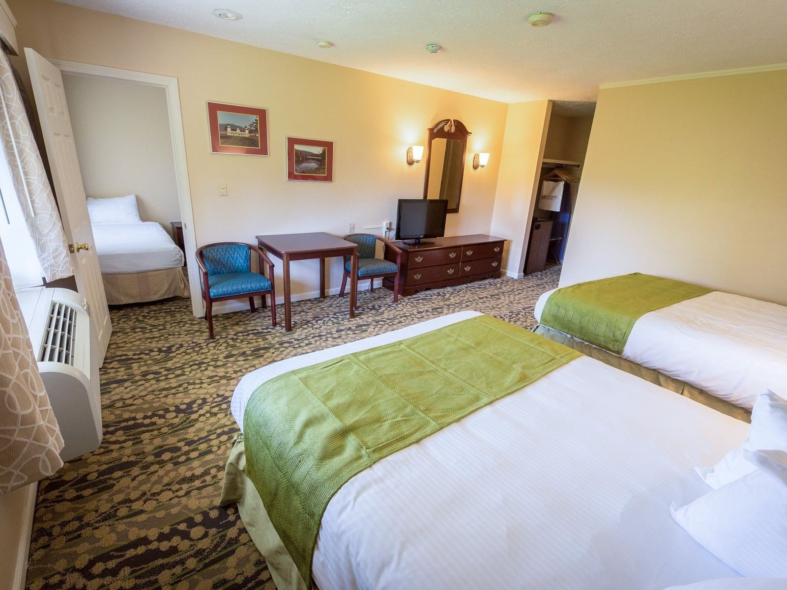 Alcove Room at Fox Ridge Resort in Conway with two beds, furniture, and a small kitchen area.