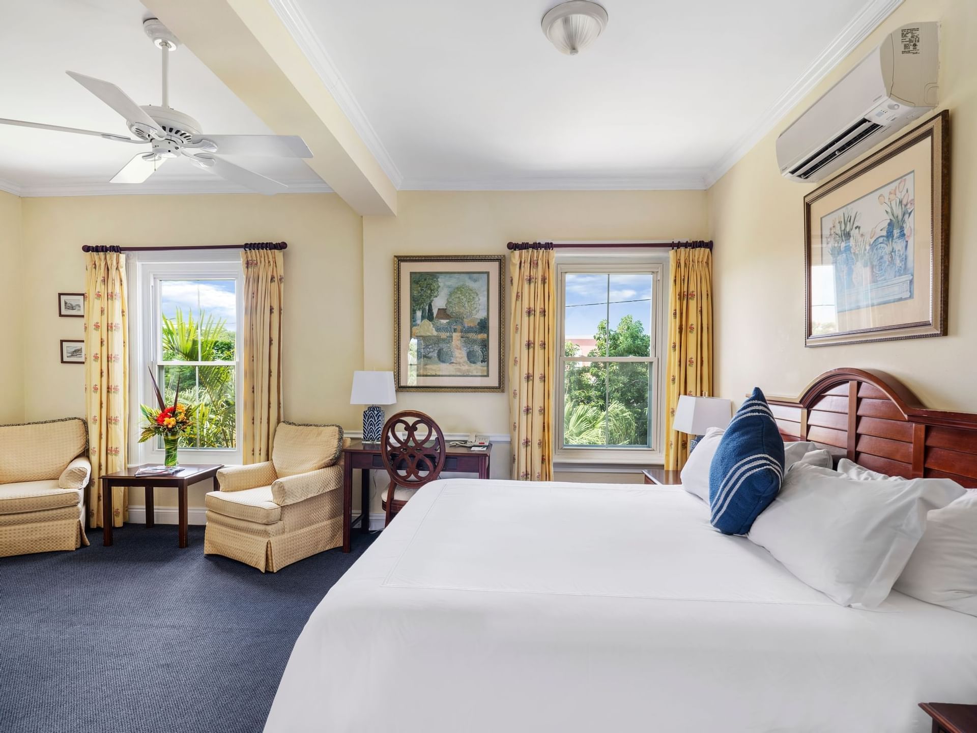 Deluxe Mini Suite with a cozy bed and a living area at Royal Palms Hotel