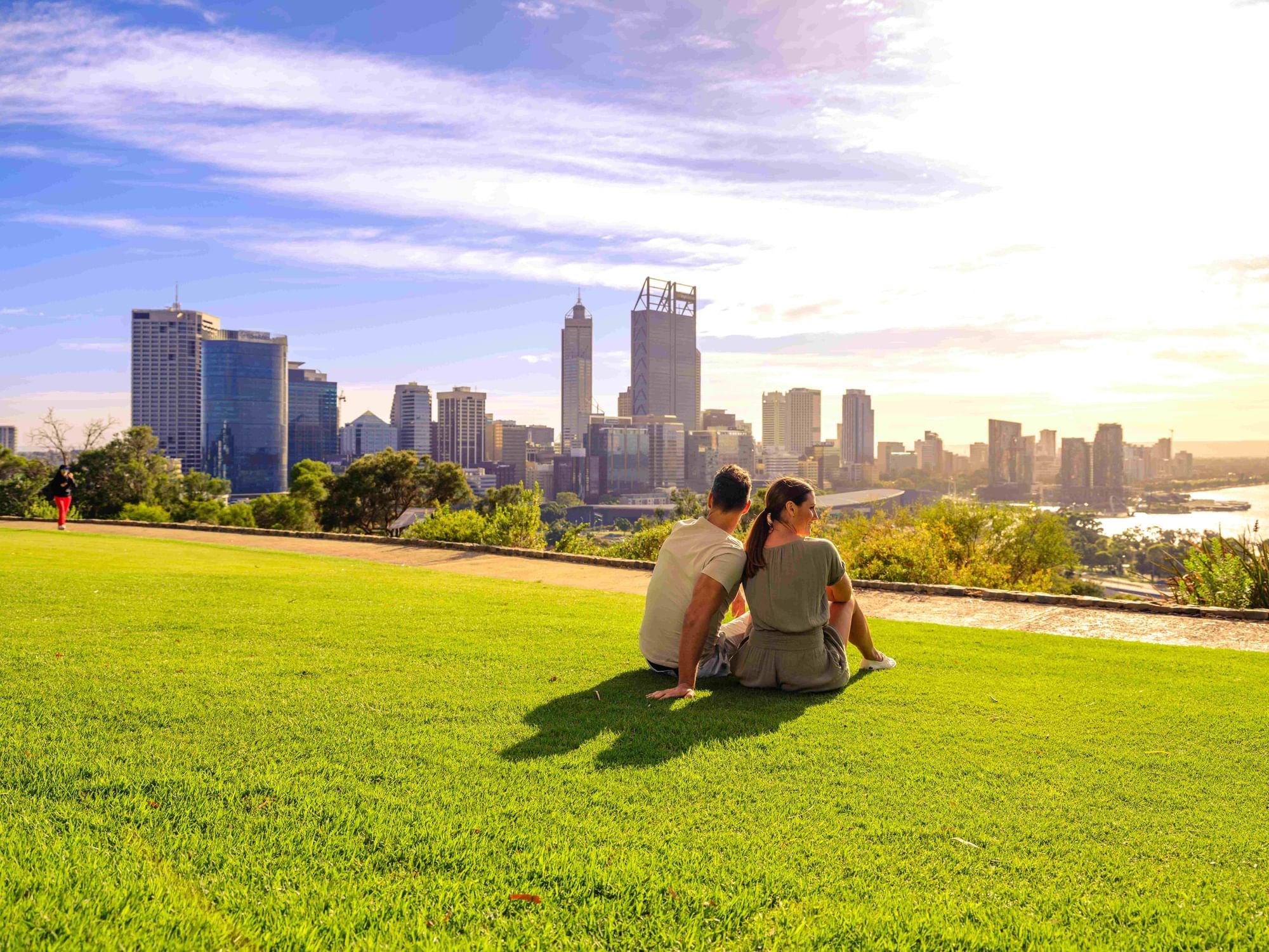Couple enjoying outdoors on lawn in Kings Park near Melbourne Hotel Perth