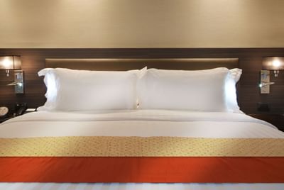 Two pillows on the bed in Neo Deluxe room at Amora Neoluxe Hotel Bangkok