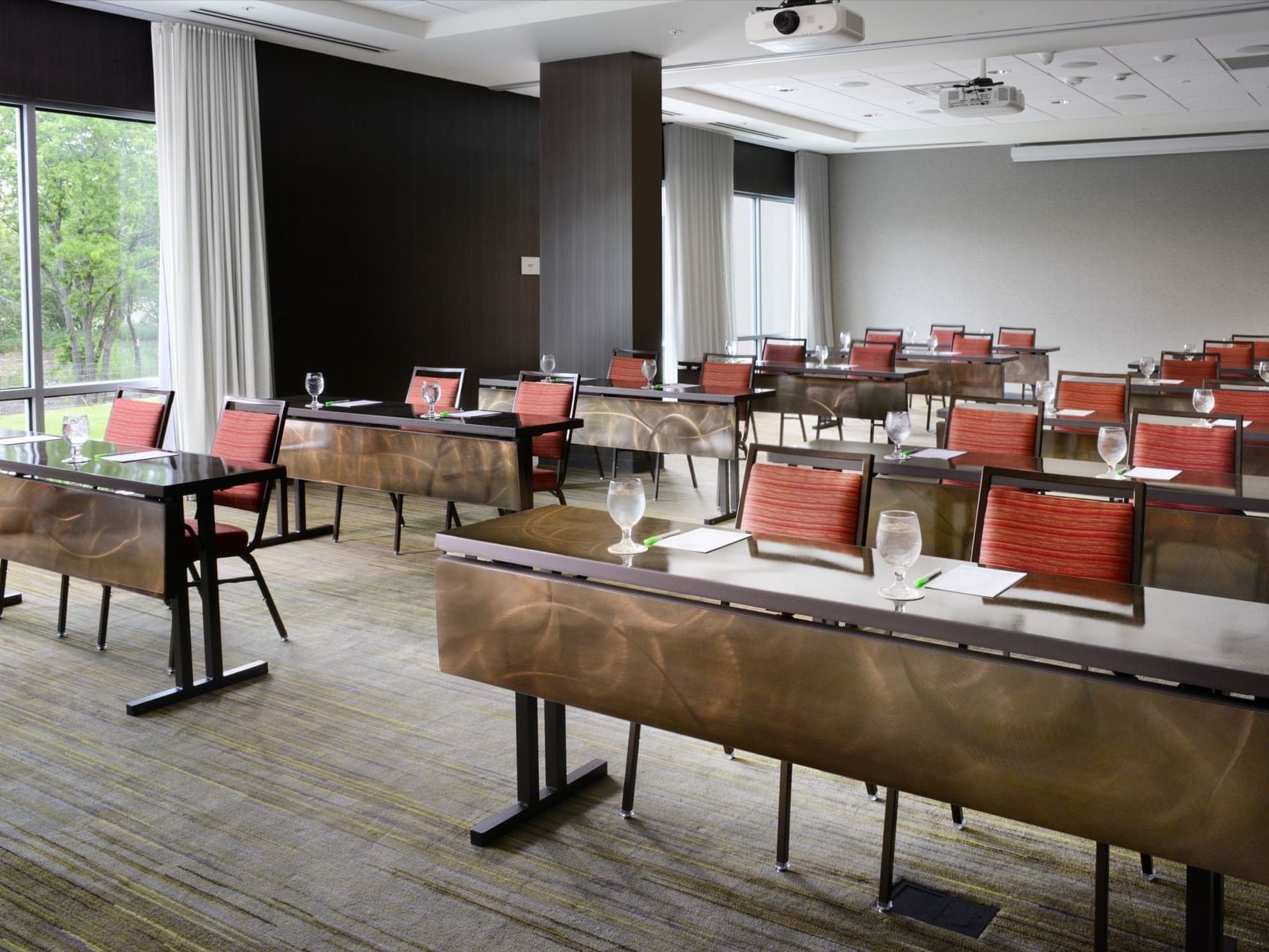 conference room with long tables and red chairs