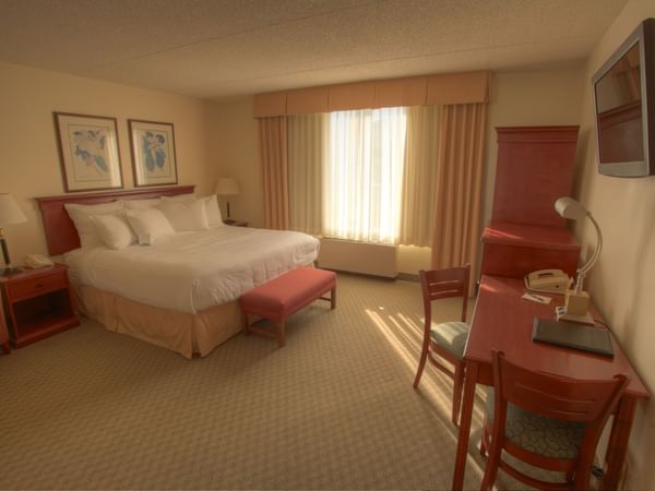 King bed and desk in hotel room