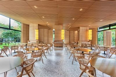 Wooden tables & chairs in a dining area at Goodwood Park Hotel