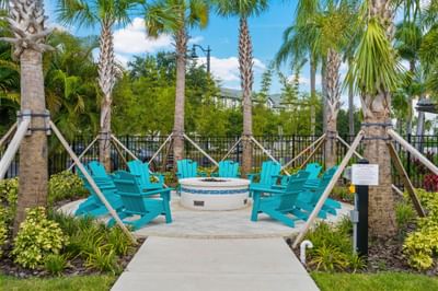 Blue chairs surround a fire pit at Vista Cay Resort By Millenium.