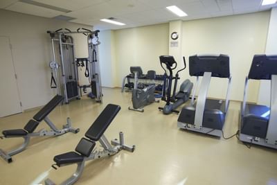 The fitness center with cardio and weight machines along the walls at the Schulich School of Business.