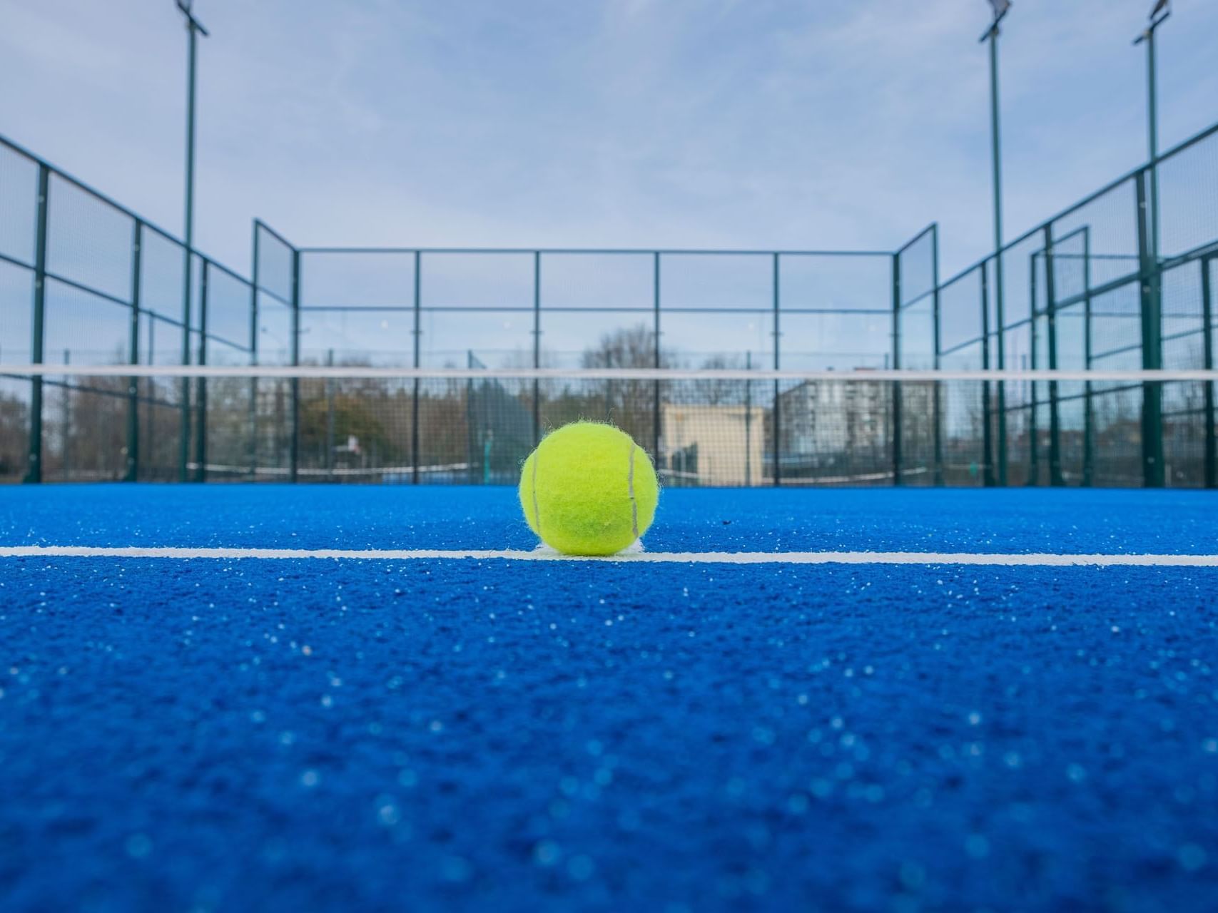 A tennis ball on a court at Metropolitan Al Mafraq Hotel