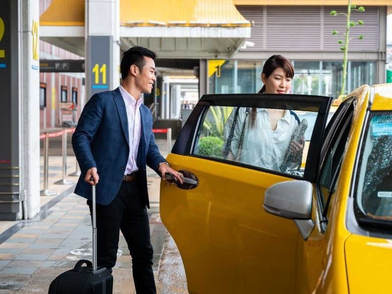 Man and Woman at airport getting picked up by their airport shuttle service