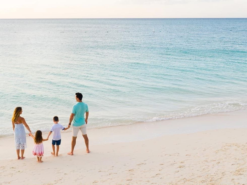 Family on the beach near The Somerset On Grace Bay