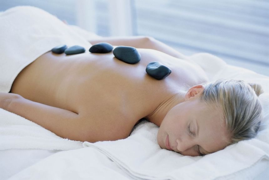 A lady relaxing with stone therapy at The Herrington Inn & Spa
