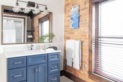 Bathroom vanity & a mirror in Apartment 403 at Retro Suites Hotel