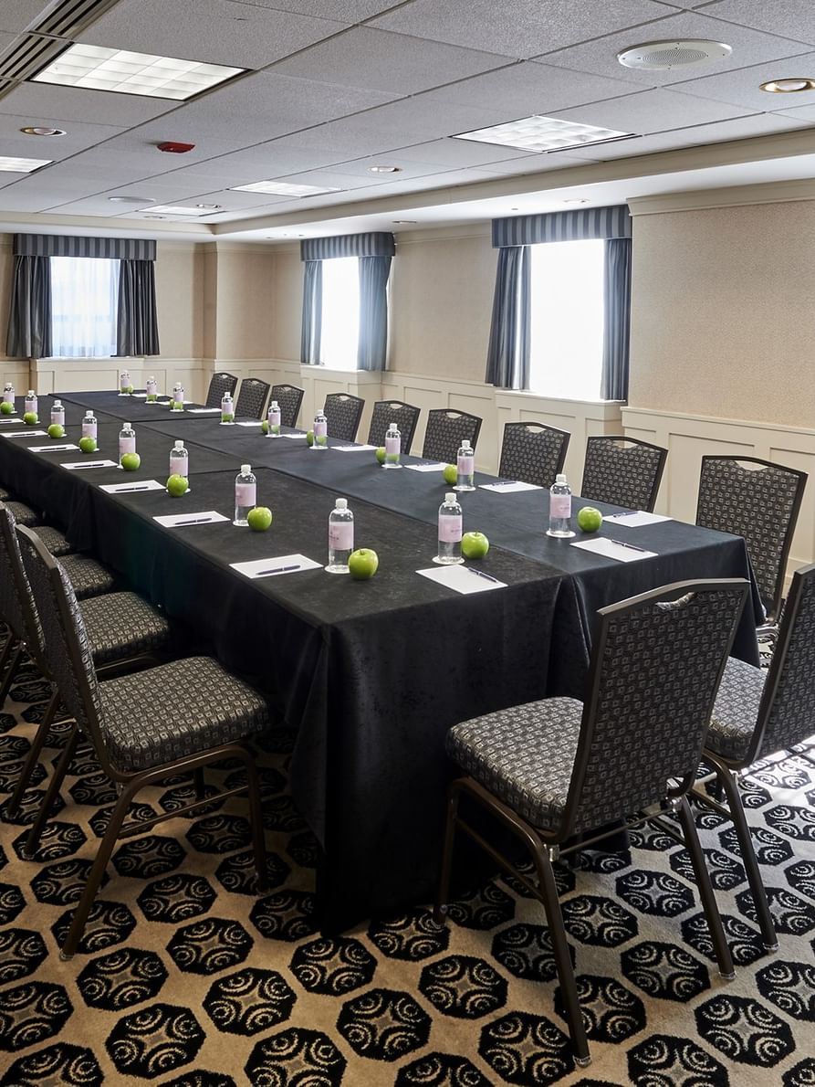 Long table with chairs and bottles at Mies Van Der Rohe Room in Chicago at Warwick Allerton.