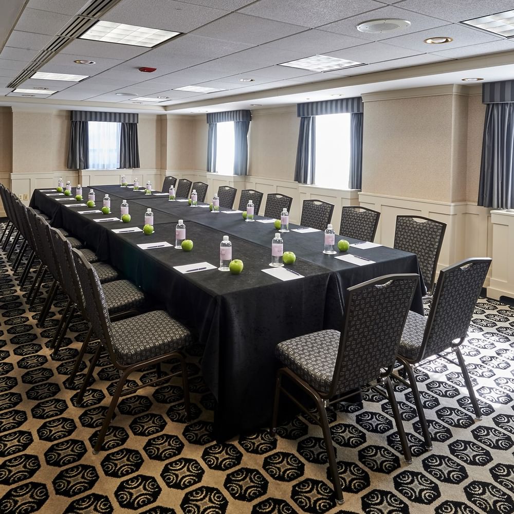 Long table with chairs and bottles in Mies Van Der Rohe Room at Warwick Allerton Chicago