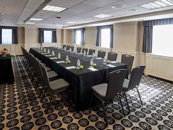 Long table with chairs and bottles in Mies Van Der Rohe Room at Warwick Allerton Chicago