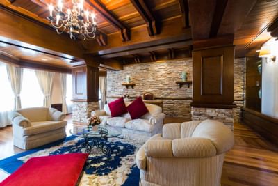 A seating area with white couches and a glass coffee table