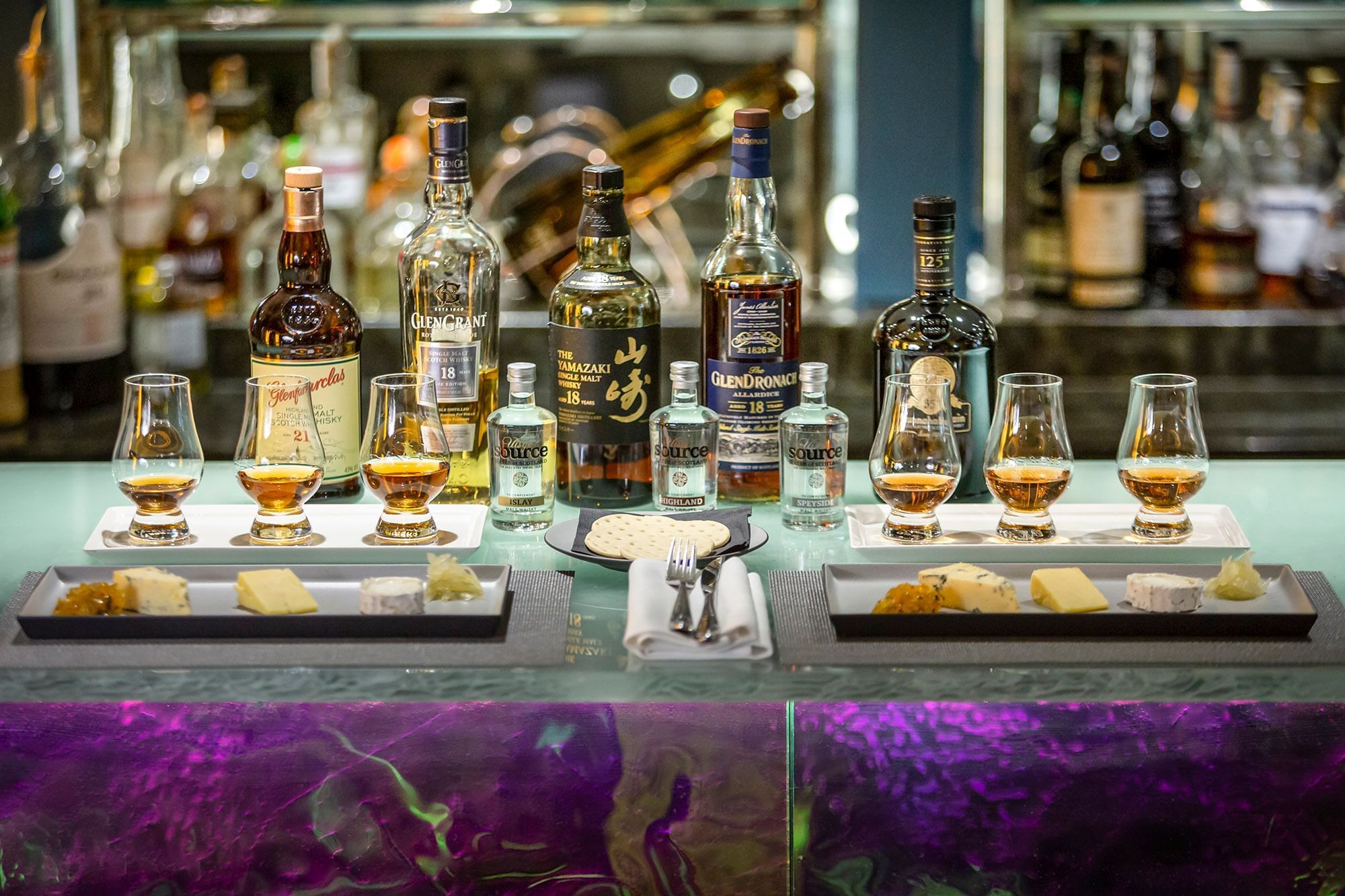 Whiskey bottles served with side dishes in Capital Hotel Bar