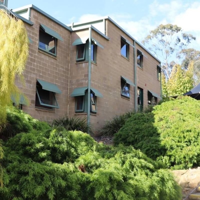 Stairs leading to La Trobe University - Units building with lush greenery.