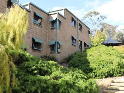 Stairs leading to La Trobe University - Units building with lush greenery.