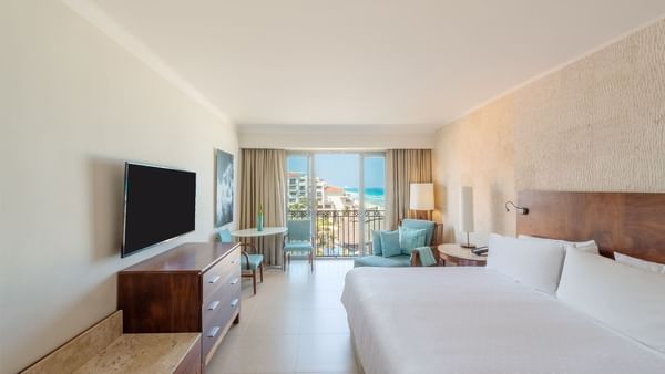 TV & sitting area by the bed in Premium Ocean View, 1 King at Fiesta Americana