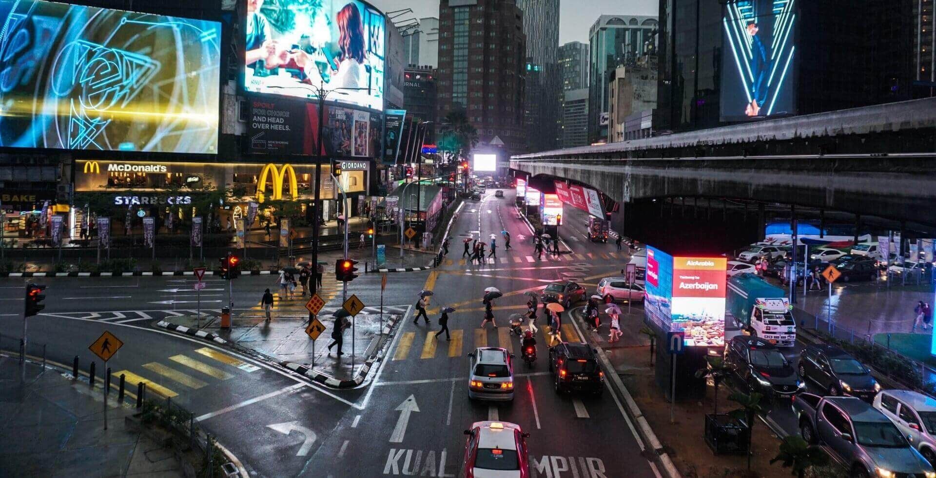 Nighttime view of Bukit Bintang with people in streets near Sunway Velocity Hotel