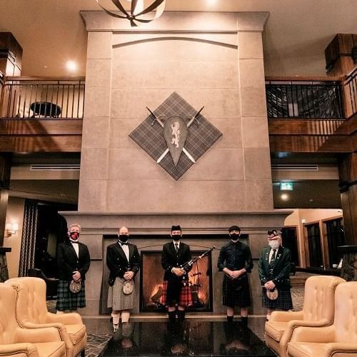 Bagpipers standing by the lobby fireplace at The Malcolm Hotel