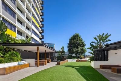 Hotel outdoors with a greeny front garden and arranged seating in patio area at Alcyone Hotel Residences