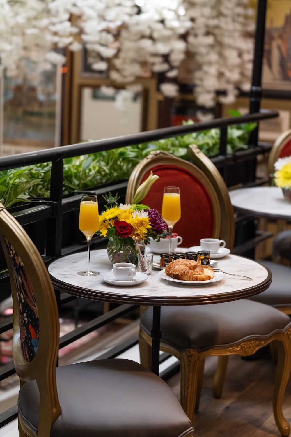 a table set for breakfast with orange juice, coffee, and pastries