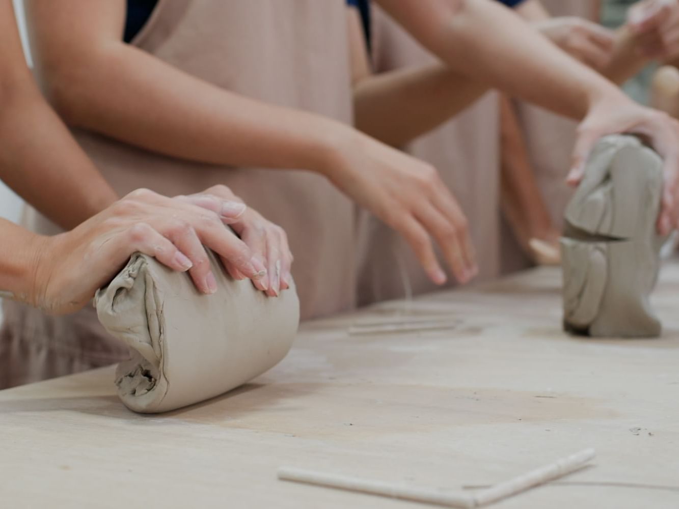 People wedge clays at Georgetown Pottery near Ogunquit Collection