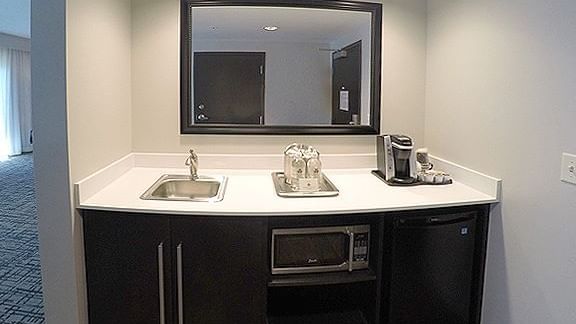 Kitchenette with a mini fridge & coffee maker in Double Queen Suite Balcony at Shangri-La Monkey Island