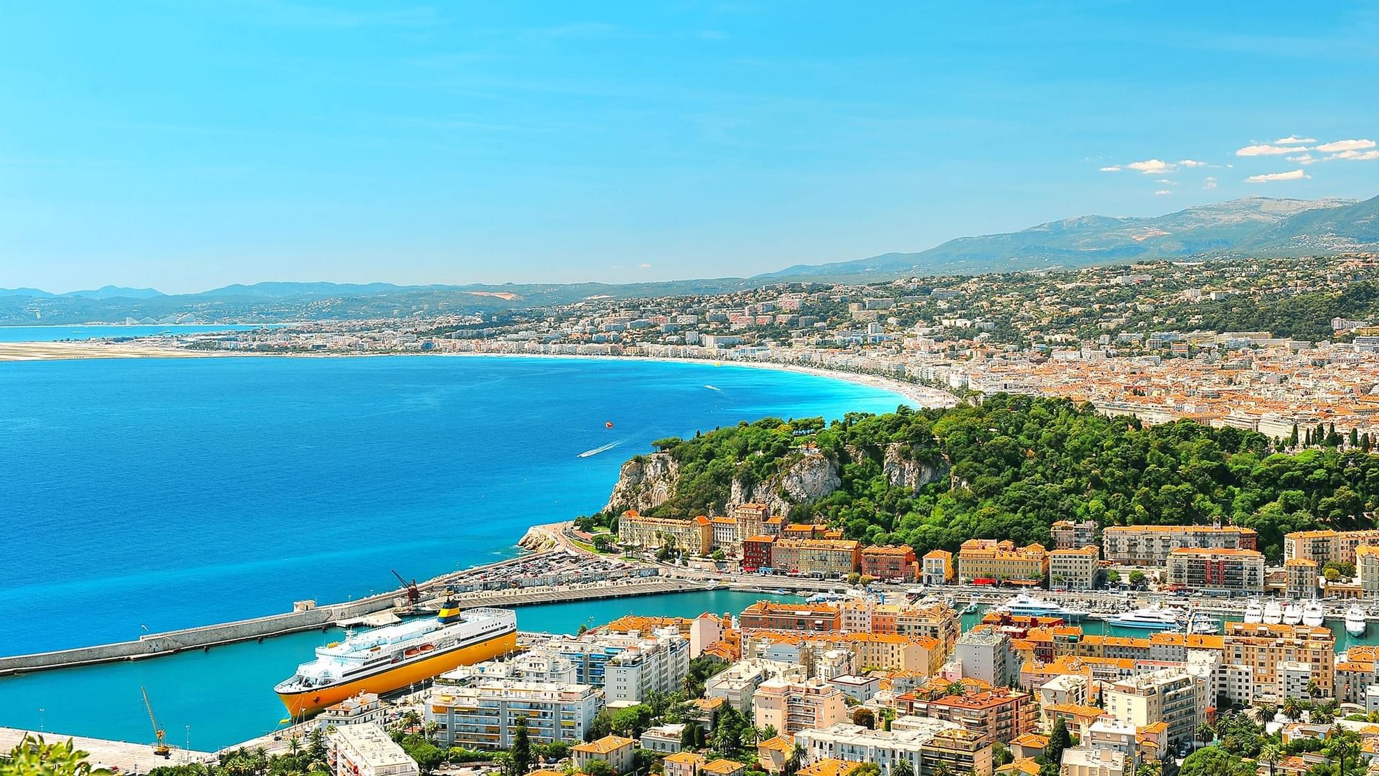 Aerial view of Nice city with sandy beaches, a marina, and hills featuring locations near Warwick Hotels and Resorts