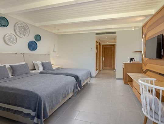 Twin beds & TV in Swim-up Standard Room at Titanic Luxury Collection Bodrum.