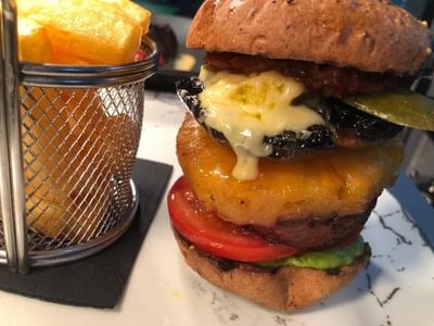 Close-up of a Juicy vegan burger & fries at Orsett Hall Hotel